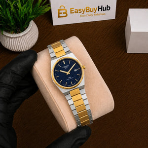 A wristwatch with a blue dial and two-tone silver and gold metal bracelet, displayed on a beige cushion held by a hand in a black glove. A branded card reading EasyBuyHub is visible in the background on a wooden surface.
