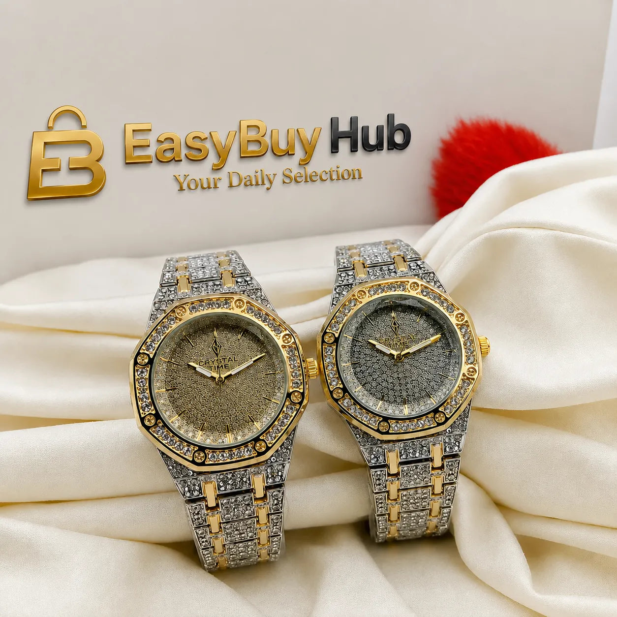 Two luxury-style wristwatches with gold and silver-tone cases covered in rhinestones, displayed on draped cream fabric. One watch has a gold dial and the other has a silver dial.