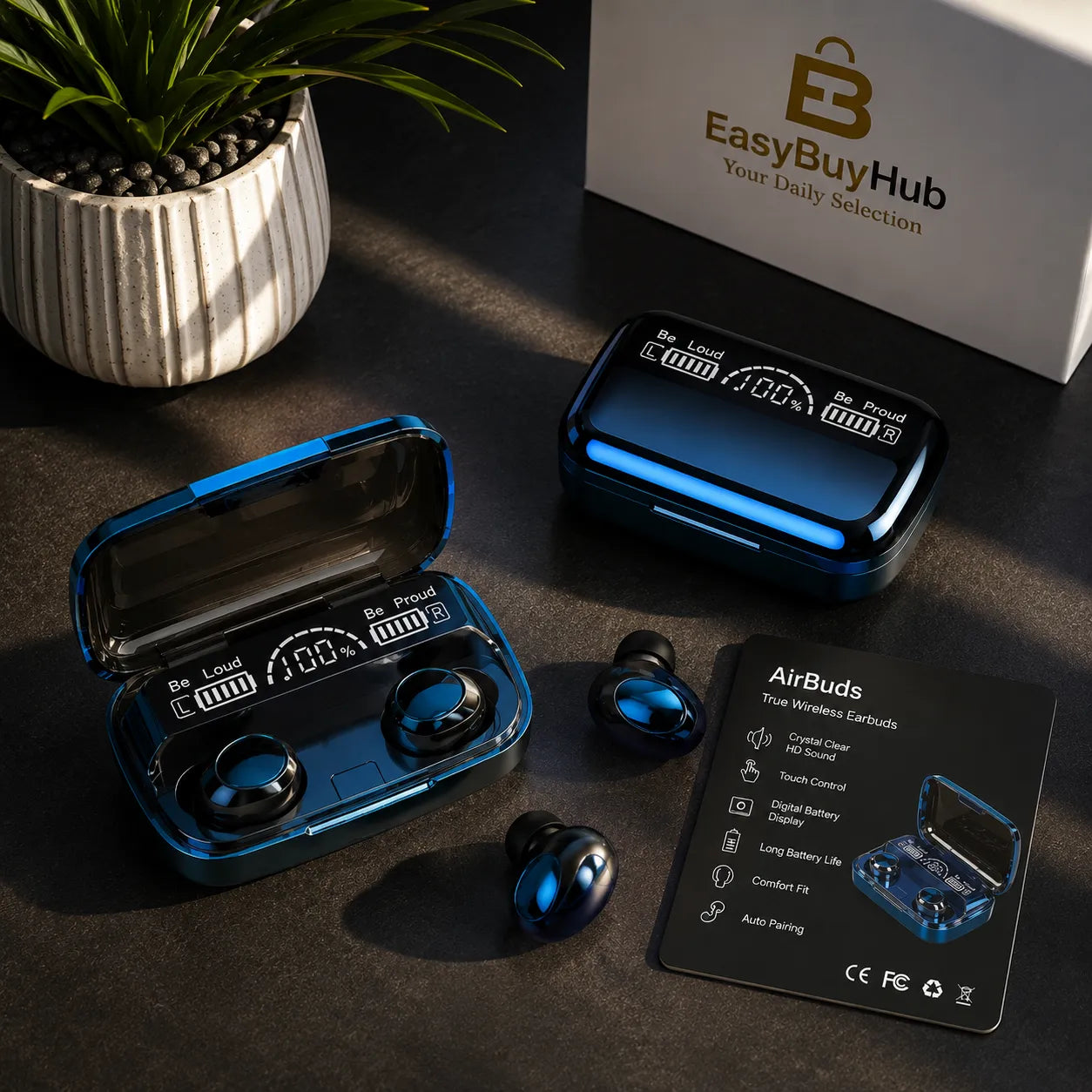Blue wireless earbuds and their charging case arranged on a dark tabletop, with a product box labeled EasyBuyHub in the background and a black card showing product features. No person or animal is present.