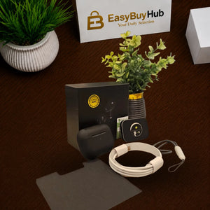 A set of wireless earbuds and accessories arranged on a dark brown textured surface, including a black charging case, a white wired earbud case, a small black charging dock, a gray cleaning cloth, and a card. A white sign reading EasyBuyHub is visible in the background along with potted plants.